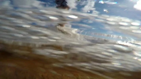 An underwater shot of boy playing in the waves on a beach Stock Footage 82519852