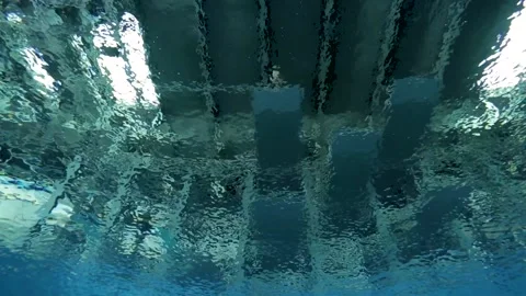 Underwater shot of diver jumping into in deep olympic swimming pool Stock Footage 135095332
