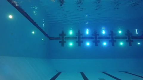 Underwater shot of man diving into deep swimming pool Stock Footage 49550061