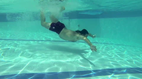 Underwater Shot of Man Diving in Pool. Slow Motion Stock Footage 25332453