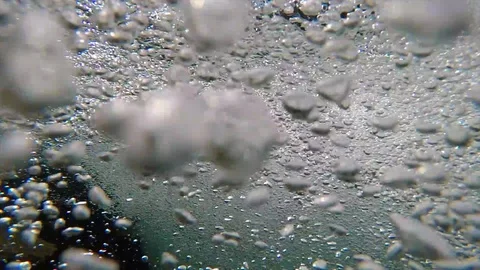 Underwater shot of powerful river rapids, small bubbles forming, slow Stock Footage 129073318