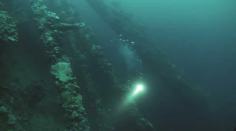 Underwater shot of scuba divers exploring sunken ship wreck 動画素材 49632454
