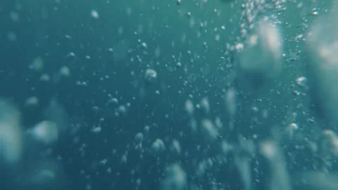 Underwater shot of sea surface with sun ray and water bubbles Stock Footage 156448431