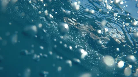 Underwater shot of sea surface with sun ray and water bubbles Stock Footage 156448818