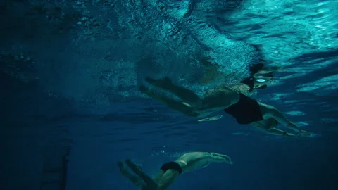 Underwater shot of two swimmers in the pool Stock Footage 283137381