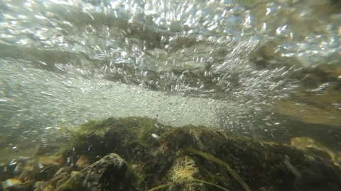 Underwater shot with water bubbles of a small creek Stock Footage 86760069