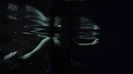 Underwater Shot Of A Woman Swimming In Dark Stock Footage