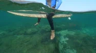 Underwater Slow Motion Relaxed Surfer Sitting On Surfboard On Sunny Day In Lobos Stock Footage
