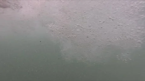 Underwater slow motion video showing air bubbles and wave movement with for.. Video stock 314272015
