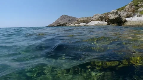 Underwater split level, coastal rocky landscape with rocky shore and underwater Stock Footage 255111825