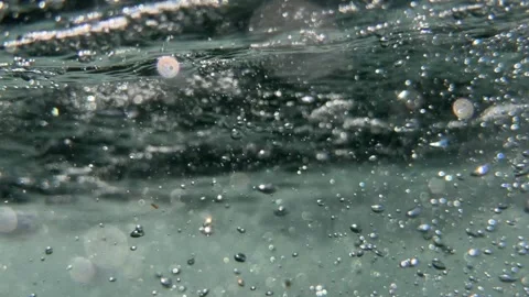 Underwater stream of air bubbles moves through seawater beneath the surface. Bub Stock Footage 341806903