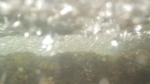 Underwater of a stream with water bubbles, the waters of the creek runs fast Stock Footage 86758944