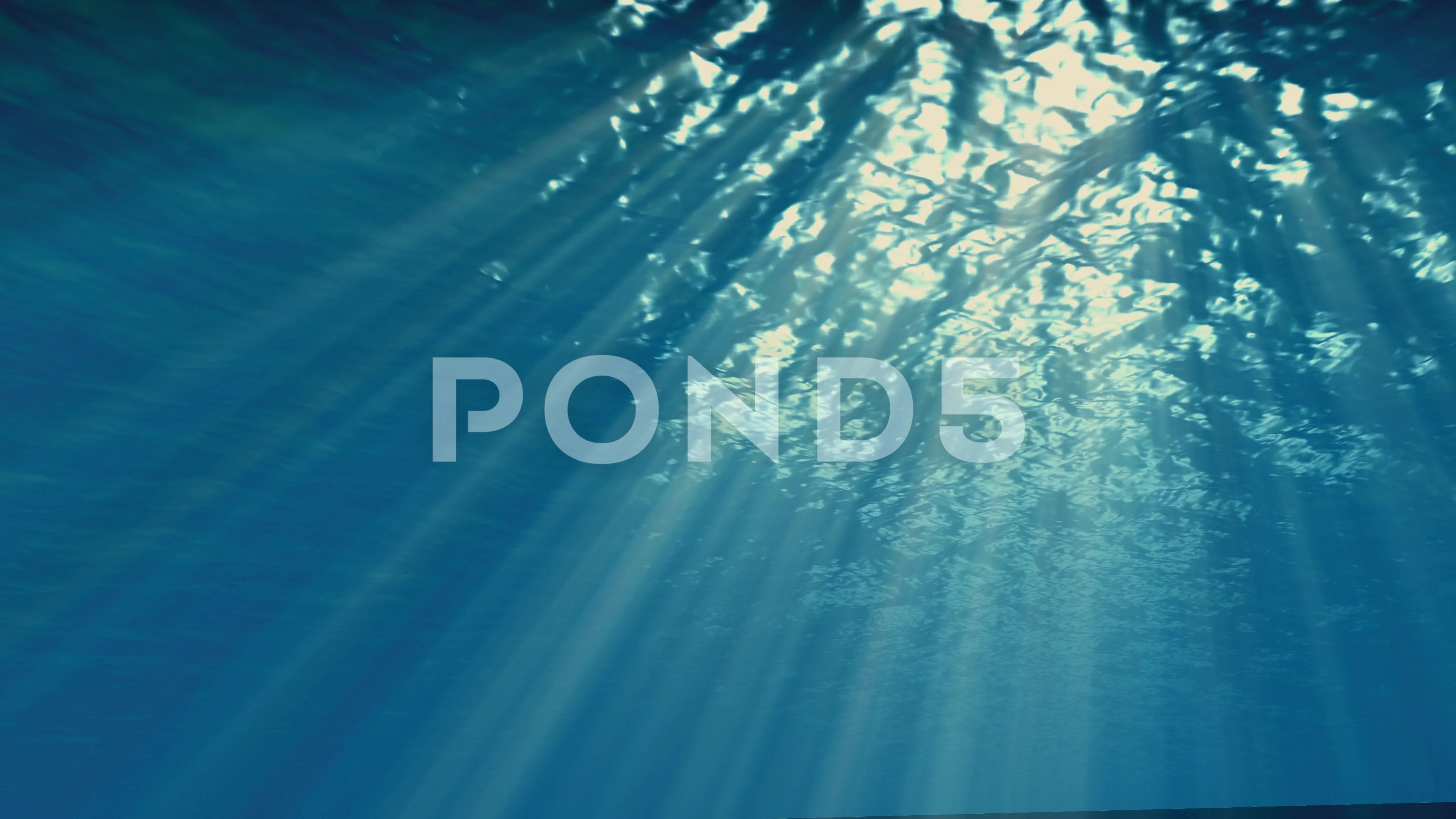 Underwater blue background in ocean with sunbeams Stock Photo