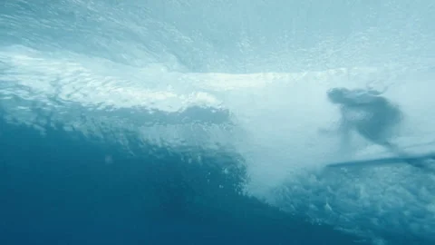 Underwater surfer riding on a wave rolling in Stock Footage 169057944