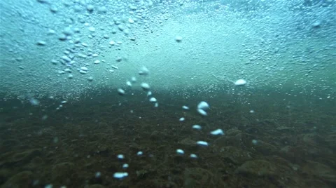 Underwater turbulence in the river forming bubbles in super slow motion Stock Footage