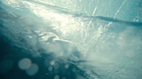 Underwater turbulence vortex bubbles beneath breaking ocean wave slow motion Stock Footage 333449181