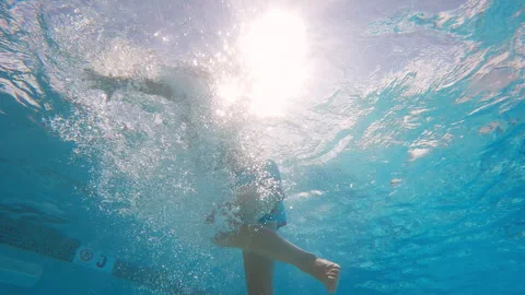 Underwater view of 7 year old doggy paddling, struggling, swimming in pool Stock Footage 248081681