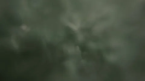 Underwater view with air bubbles ascending through murky green water, creating a Stock Footage 343076252