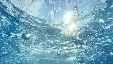 Underwater View of Air Bubbles Rising to Clear Water Surface Stock Footage 342764207
