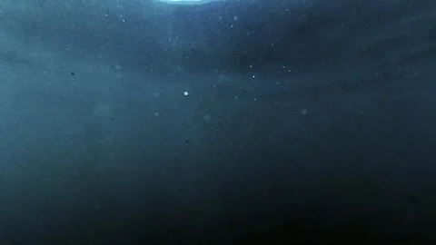 Underwater view below the ocean floor with sunlight shining through the water's  Stock Footage 250159739