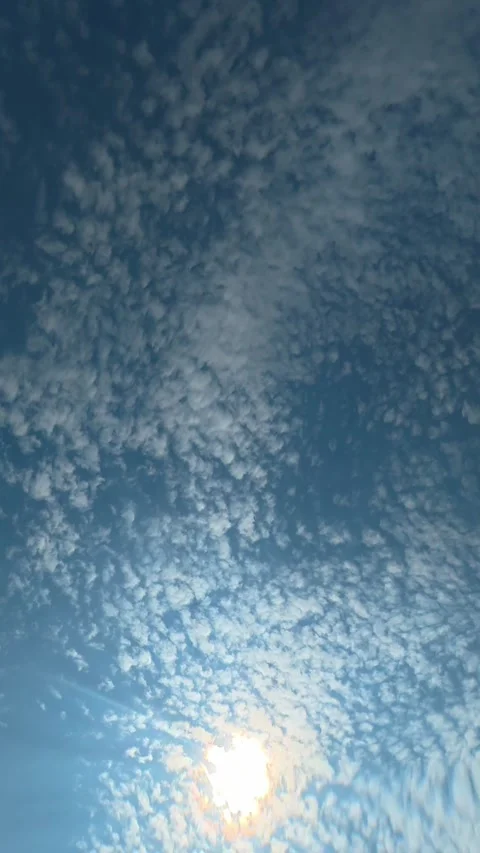 Underwater view of blue sky and clouds through gently rippling water surface Stock Footage 342046683
