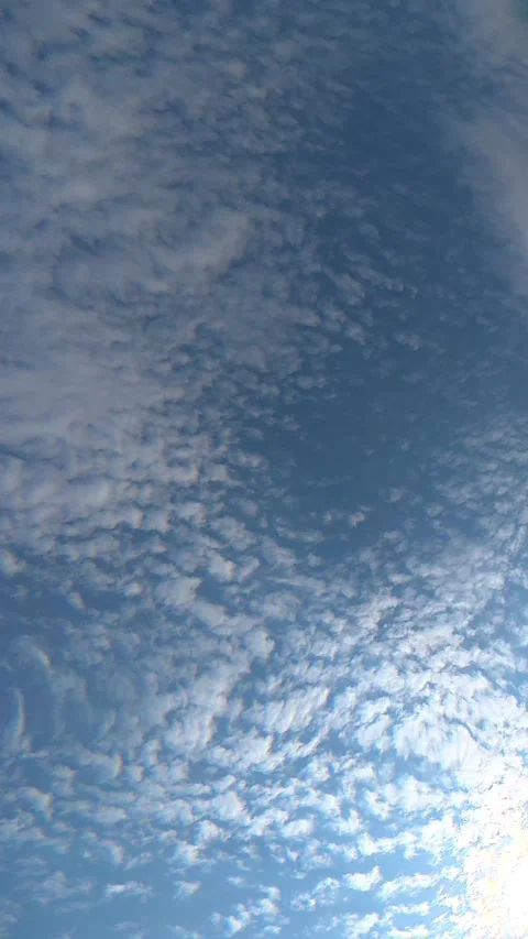 Underwater view of blue sky and clouds through gently rippling water surface Stock Footage 342046957