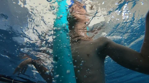 Underwater view of boy trying to swim Stock Footage 90077227