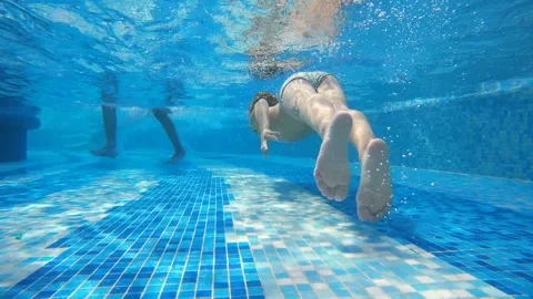 Underwater view of a child diving in the pool Stock Footage 202288427