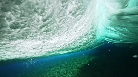 Underwater view of clear ocean wave breaking over corral reef. spinning vortex. Stock Footage 208537756