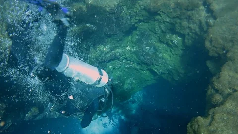 Underwater view of diver diving into underwater cave in blue hole in Florida. Stock Footage 122479536