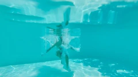 Underwater View Of Man Jumping In A Pool Stock Photos