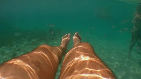 Underwater view of man legs floating with people Stock Footage 278848199