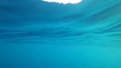Underwater view of the ocean surface with light rays penetrating the water Stock Photos