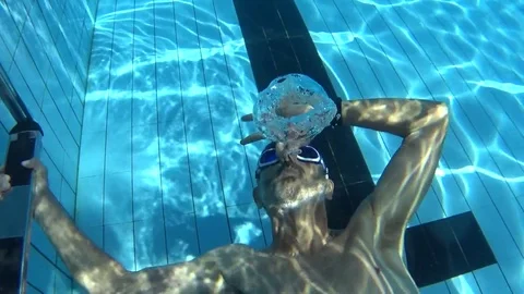 Underwater view old man play in pool Stock Footage 82057188