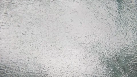 Underwater View of Rain Hitting Sea Surface with Ripples and Bubbles Stock Footage 341375992