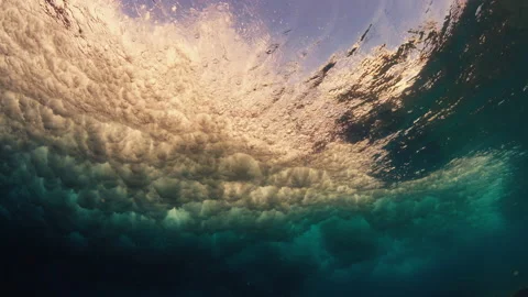 Underwater view of the rolling and breaking ocean wave and crystal clear water Stock Footage 167881713