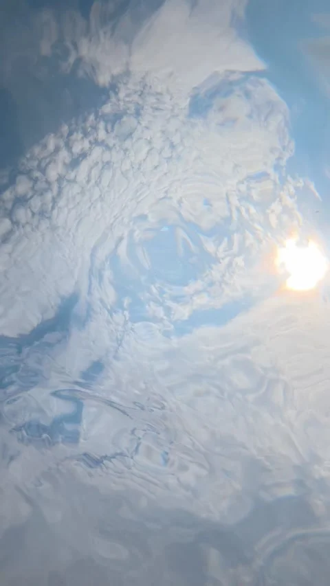 Underwater view of sun and clouds rippling on water surface Stock Footage 342161866