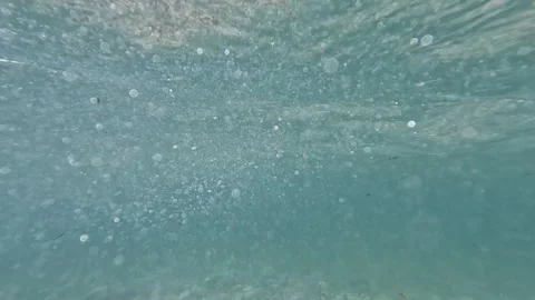 Underwater View of Sunlight and Tiny Air Bubbles Rising in Deep Blue Sea Stock Footage 322164869