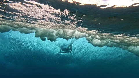 Underwater view of surfer dive under wave breaking over coral reef. Oahu Hawaii Stock Footage 284896219