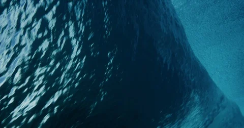 Underwater view of surfer getting barreled on blue ocean wave Stock Footage 114695014