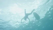 Underwater View Of Surfer Paddling Surfboard Stock Footage