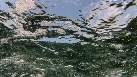 Underwater water surface and moving air bubbles create natural movement through Stock Footage 344710837
