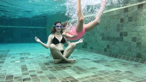 Underwater yoga practice in a swimming pool during summer Video stock 324702872
