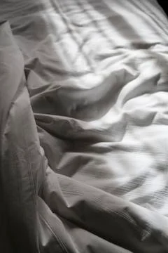 Undone bed with rays Stock Photos