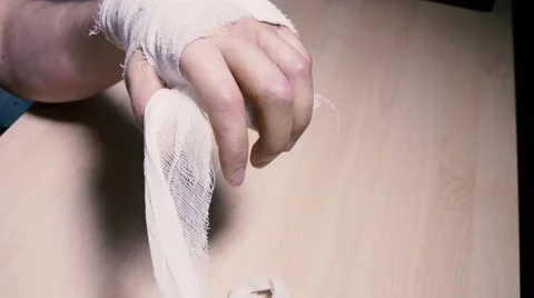 Undressing broken arm bandage Stock Footage 59977976