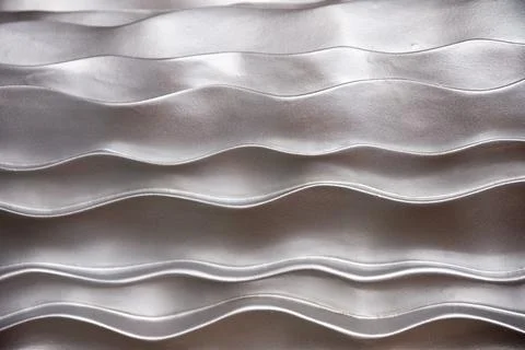 Undulating abstract of silver metallic waves Stock Photos