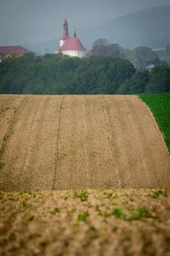 Undulating fields with a church in the background Stock Photos