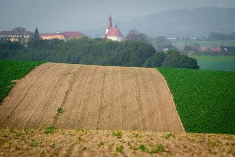 Undulating fields with a church in the background Stock Photos