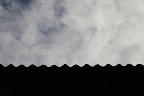 Undulating roofline against a cloudy sky moody weather scene Stock Photos