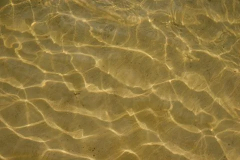 The undulating sandy bottom can be seen through the clear water with beautifu 写真素材